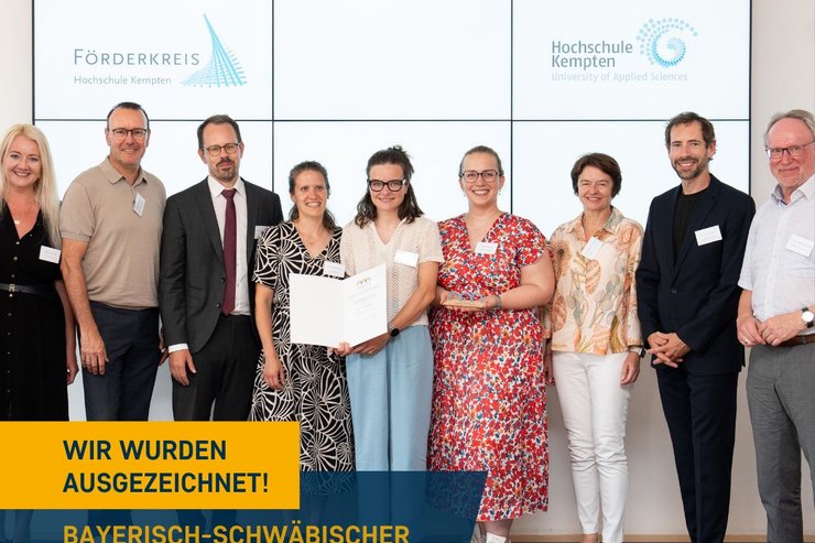 Personen vor einem großen Bildschirm während einer Preisverleihung