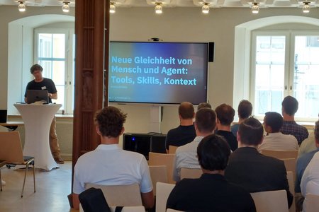 Ein Vortrag mit Bildschirm und Rednerpult 