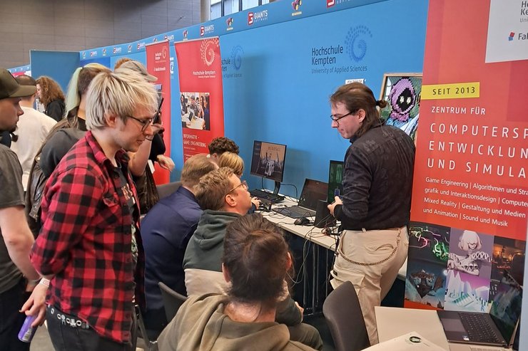 Viele Besucher informieren sich am Stand der Hochschule über Spiele und das Studium.
