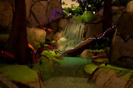 Spielszene im Urwald mit Felsblöcken, Wasserfall und Fluss und vielen Rank-Pflanzen und Farnen
